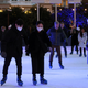 Skaters on the ice rink at the Natural History Museum in central London on December 9, 2021.